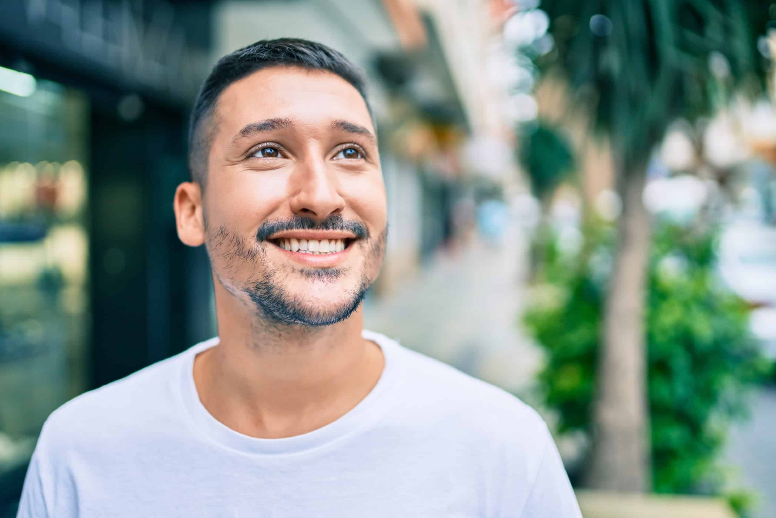 Young,Hispanic,Man,Smiling,Happy,Walking,At,Street,Of,City.